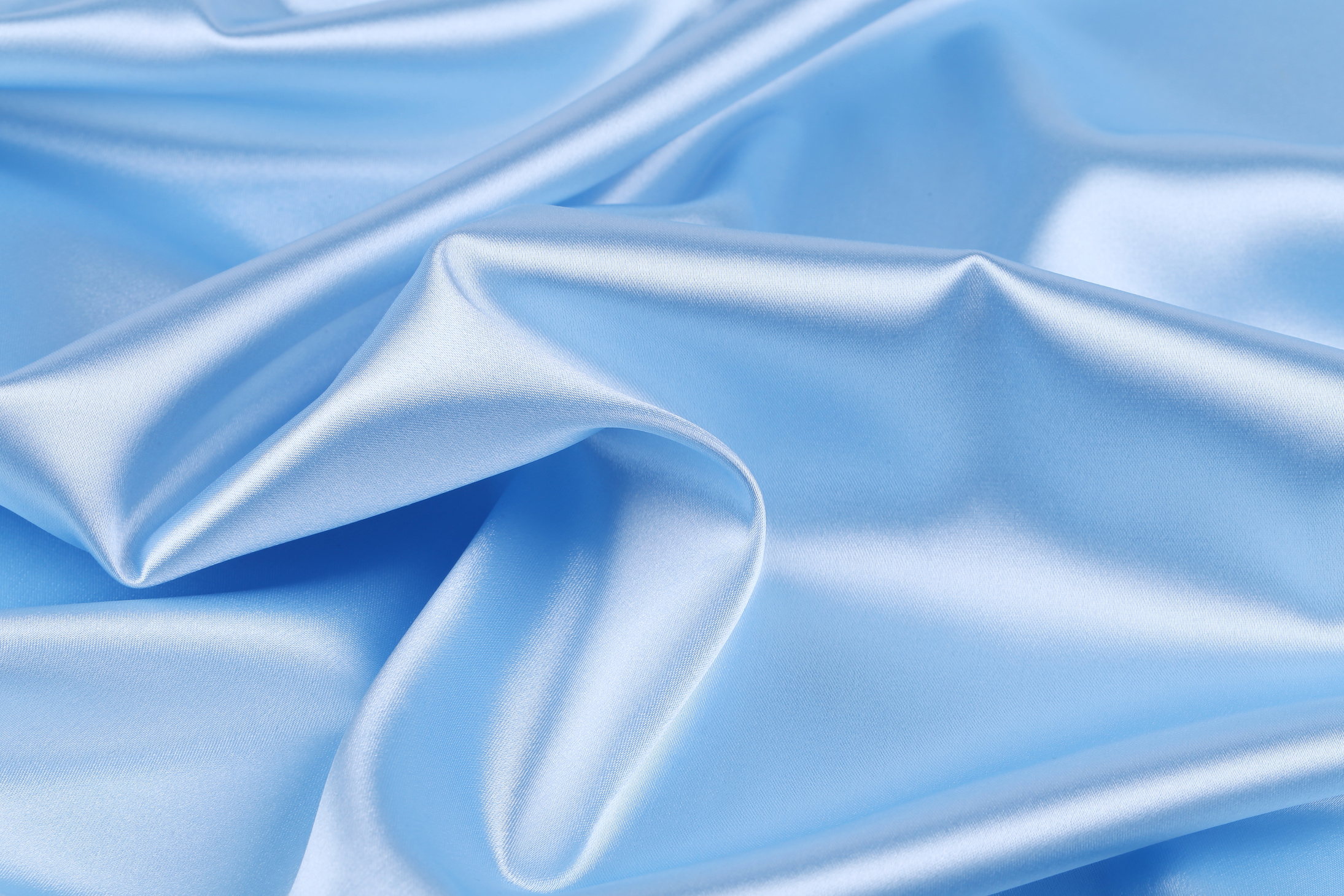 Soft folds and highlights of light blue silk.